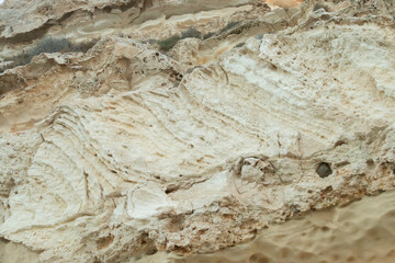 Pared de acantilado de roca sedimentaria en Las Negras, Almería, España. Pared afectada por la erosión marina en las costas de cabo de Gata en el mar Mediterráneo. - obrazy, fototapety, plakaty