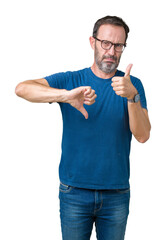 Naklejka premium Handsome middle age hoary senior man wearin glasses over isolated background Doing thumbs up and down, disagreement and agreement expression. Crazy conflict