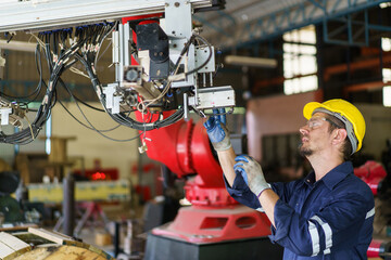  Robotic technician repairing - fixing a automated machine.