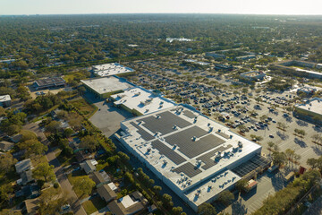 Electric photovoltaic solar panels installed on shopping mall building rooftop for production of...