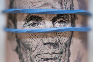 Close-up of President Abraham Lincoln on a five dollar bill.
