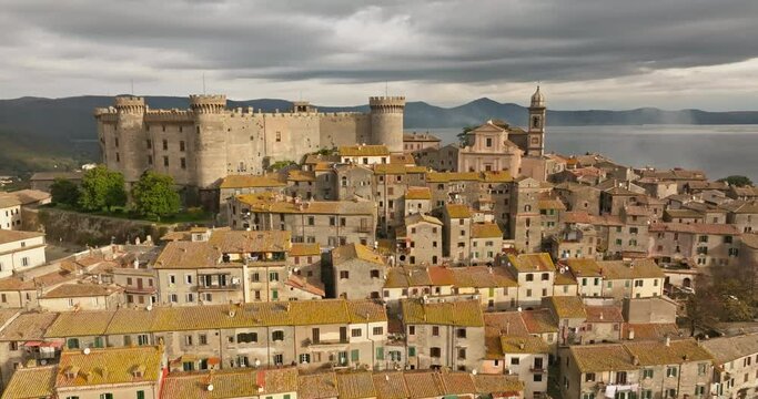 Aerial view of the castle in Bracciano Italy. A beautiful ancient defense spore on top of a mountain in a landscape of a lake in a landscape of Europe. High quality 4k footage