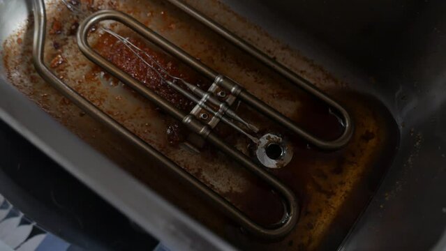 used frying oil. separation of oil from the fryer after being used. with funnel, plastic bottle and filter to retain food impurities