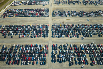 Used damaged cars on auction reseller company big parking lot ready for resale services. Sales of secondhand vehicles for rebuilt or salvage title