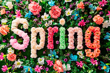 word spring surrounded by flowers in the background