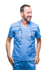 Fototapeta premium Middle age hoary senior doctor man wearing medical uniform over isolated background looking away to side with smile on face, natural expression. Laughing confident.