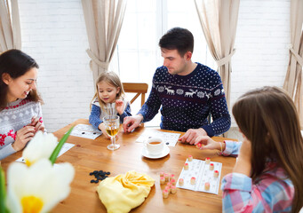 Happy young family plaing board game