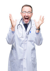 Middle age senior hoary doctor man wearing medical uniform isolated background celebrating crazy and amazed for success with arms raised and open eyes screaming excited. Winner concept