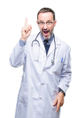 Middle age senior hoary doctor man wearing medical uniform isolated background pointing finger up with successful idea. Exited and happy. Number one.