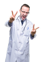 Middle age senior hoary doctor man wearing medical uniform isolated background smiling looking to the camera showing fingers doing victory sign. Number two.