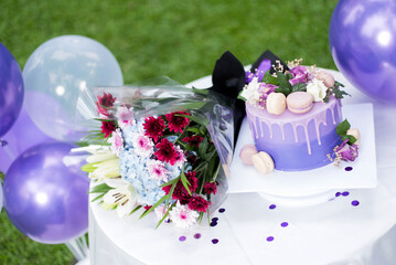 Purple birthday cake with flower bouquet 