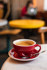 Cup of black coffee on the edge of a marble table in a cafe coffee-shop with copy space