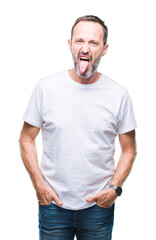 Middle age hoary senior man wearing white t-shirt over isolated background sticking tongue out happy with funny expression. Emotion concept.