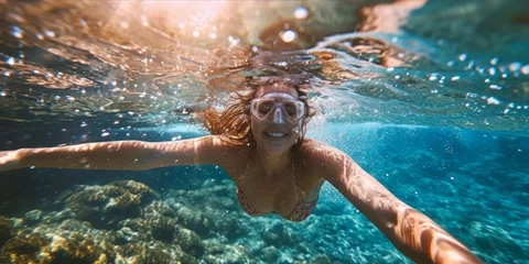 Fotobehang Young woman in snorkeling mask swimming underwater in tropical sea © YuDwi Studio