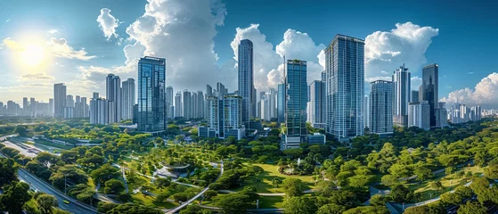 Foto op Plexiglas A panoramic view of a modern city skyline rising above a verdant urban park under a blue sky.  © Pornarun