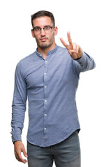 Naklejka premium Handsome young elegant man wearing glasses smiling looking to the camera showing fingers doing victory sign. Number two.