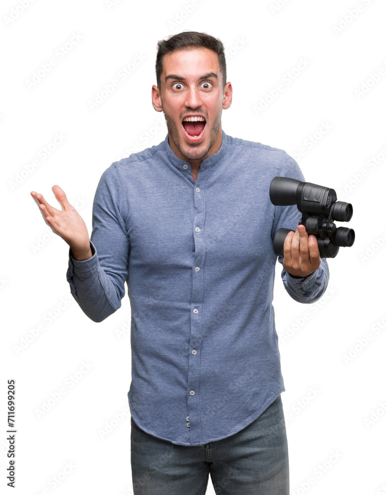 Sticker handsome young man looking through binoculars very happy and excited, winner expression celebrating 