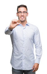 Handsome young man holding bitcoin with a happy face standing and smiling with a confident smile showing teeth