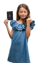 Brunette hispanic girl holding passport of United States of America pointing and showing with thumb up to the side with happy face smiling