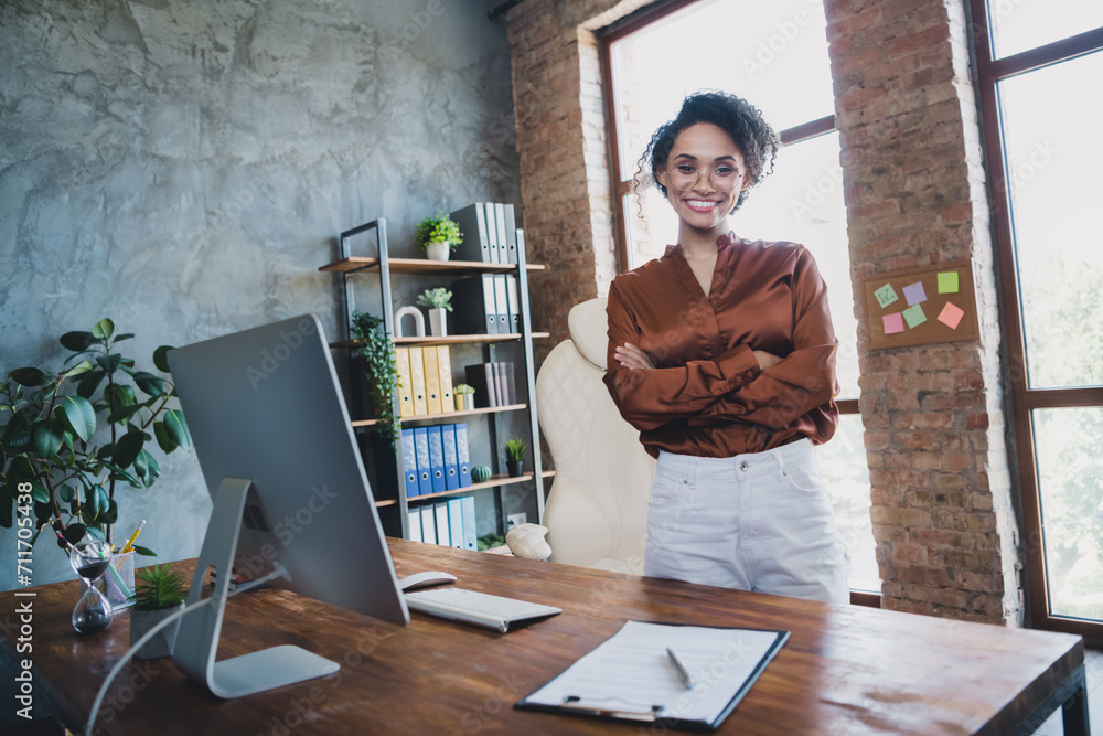 Poster portrait of pretty cheerful recruiter girl crossed hands posing modern loft interior workplace offic