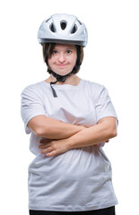 Young adult cyclist woman with down syndrome wearing safety helmet over isolated background happy face smiling with crossed arms looking at the camera. Positive person.