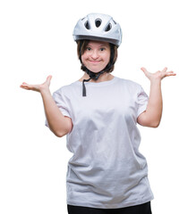 Young adult cyclist woman with down syndrome wearing safety helmet over isolated background celebrating crazy and amazed for success with arms raised and open eyes screaming excited. Winner concept