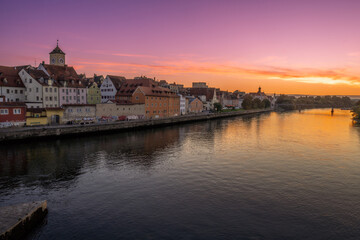 Cityscape of Regensburg at the river Daube during sunset