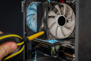 Cleaning the computer video card from dust with a brush and air. Computer fans in dust