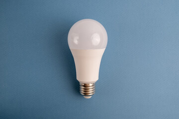 Paper and light bulb on a colored background. Idea and business concept. Place for text