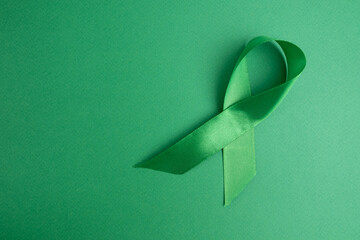 World Lymphoma Awareness Day. Green ribbon on a green background. Kidney Cancer Awareness Month....