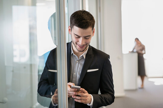 portrait likable business man small glass-walled office digitalization