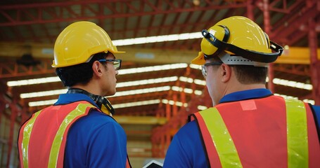 Workers partners in uniform Talking on a Meeting in Metal Construction Manufacture industry factory, Engineers man colleagues industrial discussing project work in warehouse. Team work