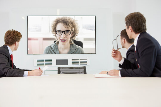 online teams meeting in large conference room with coworkers