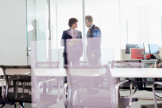 business meeting in a glass-walled conference room 