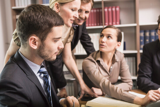 cheerful lawyers meeting in law office 