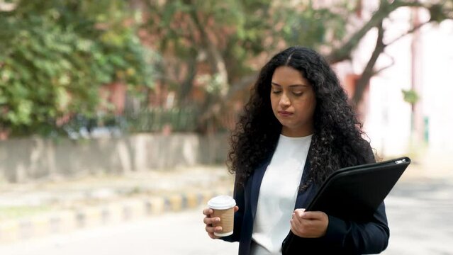 Upset Curly Hair Indian Businesswoman Walking
