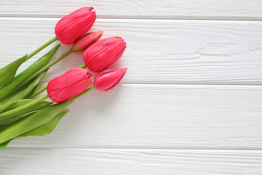 Red tulips on white wooden background, women´s day, mothers day, valentine, wedding, birthday, freeting card