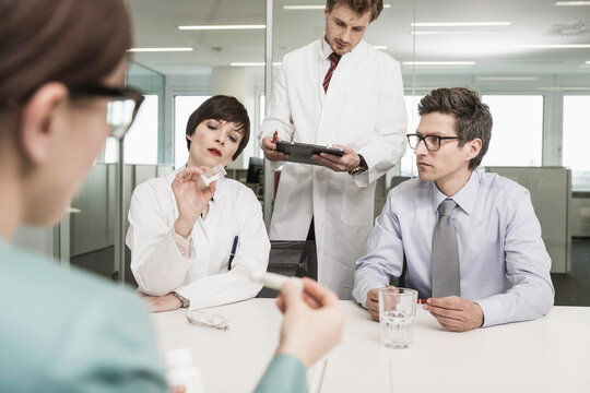 Colleagues at a pharmaceutical company meeting with clients in a conference room. Munich, Bavaria, Germany