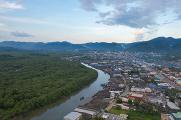 Fototapeta premium Aerial view of Ranong City, The Floating village urban city town houses, lake sea or river. Nature landscape fisheries and fishing tools, Thailand. Aquaculture farming