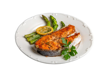 Grilled, baked salmon served on a plate with asparagus and potatoes.