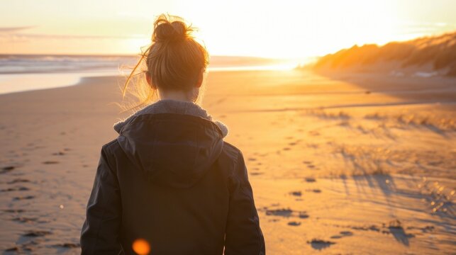 Woman with a messy bun, walking along a sandy beach during the golden hour generative ai