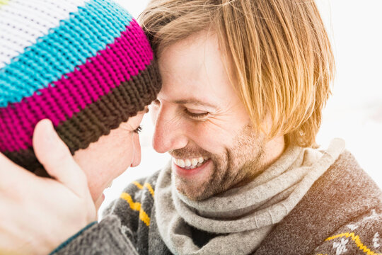 Romantic couple drinking hot tea while out in nature in the winter. Wolfratshausen, Bavaria, Germany