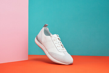 Fashion white sneaker with leather accents on pastel gradient background. Sport shoe, street wear...