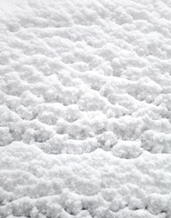 Snow on the roof of a car in winter. Close-up