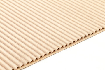 fragment of corrugated cardboard on a white background for advertising and design, close-up