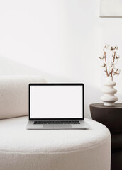 Laptop computer with empty blank mockup screen over white modern living room design. Advertisement, e-learning, shopping online, web site design, technology concept