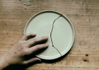 the hand that caresses the broken plate