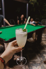 person holding a cocktail glass