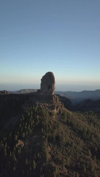 imposing cloudy rock at sunset over ravines, crossings of the summits of the Canary Islands, Gran Canaria drone recorded 4k vertical, perfect for reels 