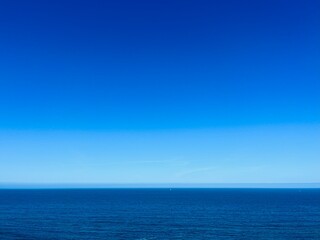 Blue seascape background, clear blue sky and blue sea horizon, natural colors